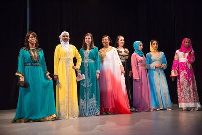 Eight women smiling and modeling; Models; women; smiling; headscarves; scarf; Hijab;  Malikah Festival